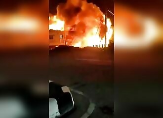 A train collides with a truck stuck on the tracks, causing a huge explosion