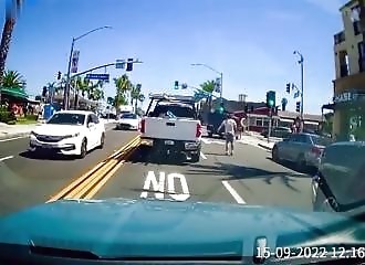 A man in a pickup truck harasses the driver of a small car, and is calmed down