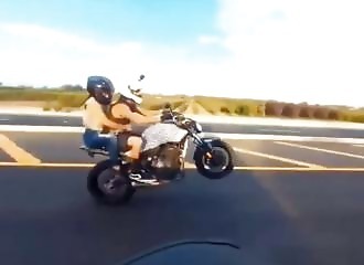 He does a wheelie with his motorcycle, it ends badly (Warning - shocking)