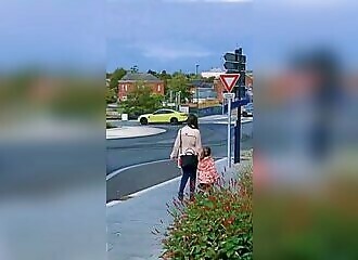 He does drifts in a traffic circle, right next to a woman and her child
