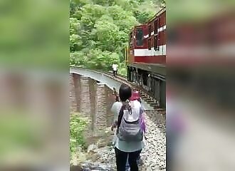 Couple jump into 90-foot abyss to avoid train during photo shoot