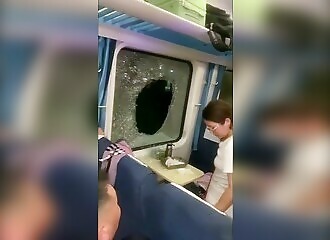  in China, a passenger breaks a window to breathe after a train accident