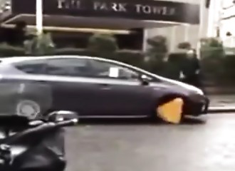 Un voiturier essaie de se débarrasser d’un sabot installé sur la voiture d’un client