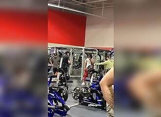A policeman comes to arrest a man in a gym, and the man gets into a fighting stance