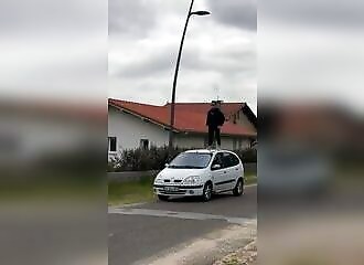 A Frenchman climbs onto the roof of his car, but things go wrong