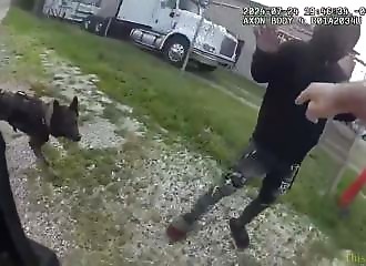 A policeman brutalizes his dog after it bites him